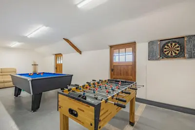 a living room with a pool table and a table at Gwrtheyrn in Dyffryn