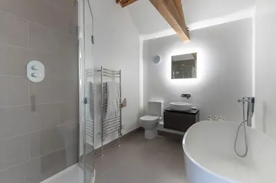 a bathroom with a tub and a toilet and a sink at The Hall in Bucknell