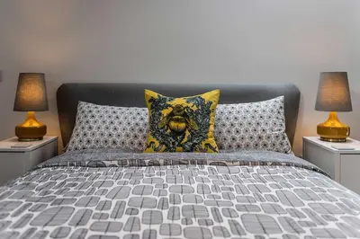 a bedroom with a bed with two lamps at The Hall in Bucknell