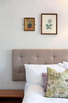 a bedroom with two pictures on the wall above a bed at Victoria Inn in Llanbedr