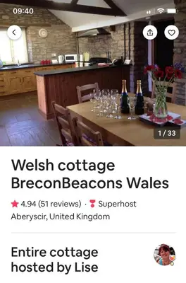 a table with wine bottles and glasses on it at Llwyn Llwyd Cottage in Brecon