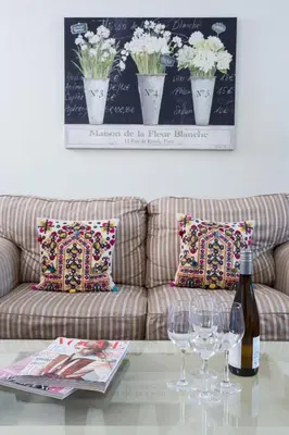 a living room with a couch with wine glasses on a table at The Old House, Llwyn Madoc in Llanwrtyd Wells