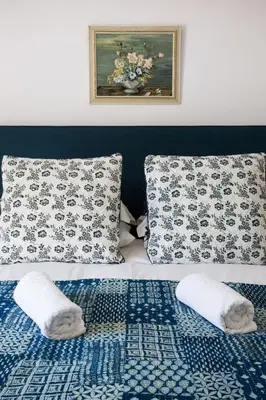 a bed with two pillows and a blue and white at The Old House, Llwyn Madoc in Llanwrtyd Wells