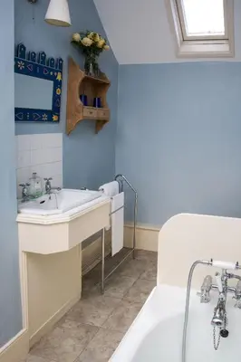 a bathroom with a white sink and a tub at The Old House, Llwyn Madoc in Llanwrtyd Wells