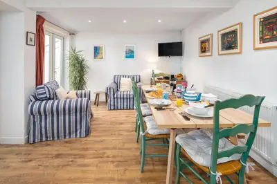 a dining room with a table and chairs at Awelfryn in New Quay