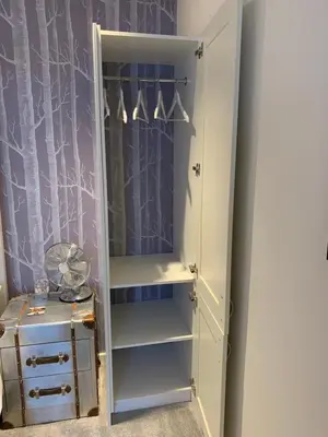 a white wardrobe with a mirror and a dresser at The Stowe in Shrewsbury