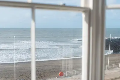 a view of the beach from a window at No 47 Marine Terrace in Aberystwyth