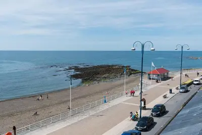 a view of a beach with cars parked on the road at No 47 Marine Terrace in Aberystwyth