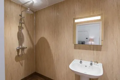 a bathroom with a sink and a mirror at No 47 Marine Terrace in Aberystwyth