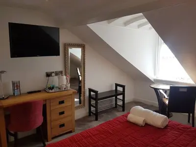 a room with a desk and a mirror and a bed at No 47 Marine Terrace in Aberystwyth