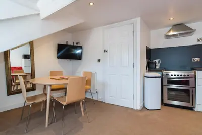 a kitchen and dining room with a table and chairs at No 47 Marine Terrace in Aberystwyth
