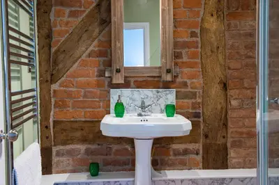 a bathroom with a sink and a mirror at The Hayloft, Wall End Farm in Leominster