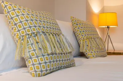 two yellow pillows on a bed with a lamp at 3 Bed in Bala oc-bow69 in Bala