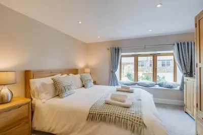 a bedroom with a large white bed with a window at 3 Bed in Bala oc-bow69 in Bala