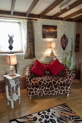 a living room with a couch and red pillows at Brecon Boutique Breaks Wild Land in Sennybridge