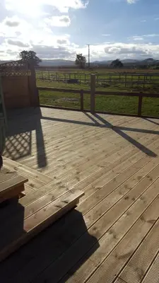 a wooden deck with a bench and a fence at Ruth's Refresh Country Retreat with Private Hot Tub & Stunning Views in Shrewsbury