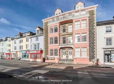 a building on the corner of a street at Westhaven One in Aberdyfi