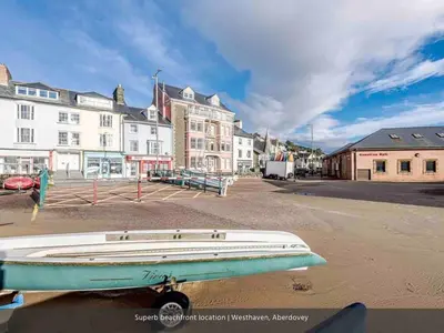 a boat sitting on the side of a street at Westhaven One in Aberdyfi