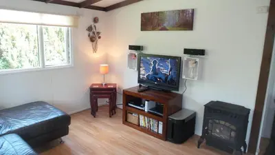 a living room with a flat screen tv and a fireplace at 28 Riverside, Caer Beris Holiday Park in Builth Wells