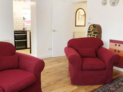 two red chairs sitting in a living room at The Hayloft in Shelve