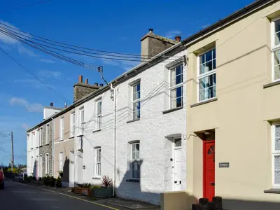 a row of white brick houses on a street at Seadrift in New Quay