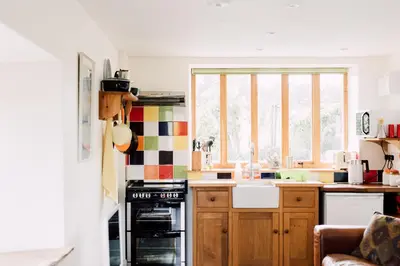 a kitchen with a sink and a stove top oven at The Barn at Ty Beic in Bala