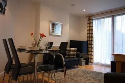 a dining room with a table and chairs at Parc y Bryn Serviced Apartments in Aberystwyth