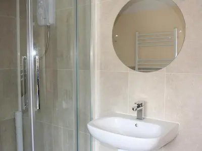 a bathroom with a sink and a mirror at The Old School House in Llanbrynmair