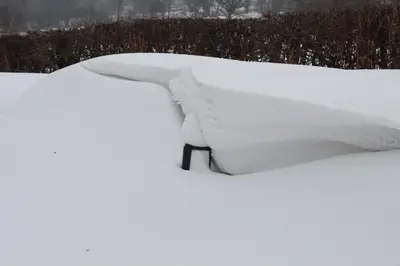 a pile of snow on top of a bench at The Old School House in Llanbrynmair