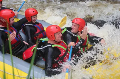 a group of people in a raft in a river at The Old School House in Llanbrynmair