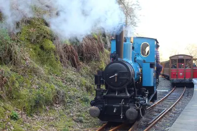 a blue train is traveling down the tracks at The Old School House in Llanbrynmair