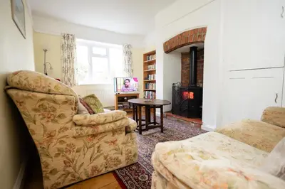 a living room with a couch and a chair and a table at Oak House in Mid Wales with Log Burner By Seren Short Stays in Machynlleth