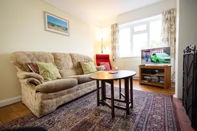 a living room with a couch and a table at Oak House in Mid Wales with Log Burner By Seren Short Stays in Machynlleth