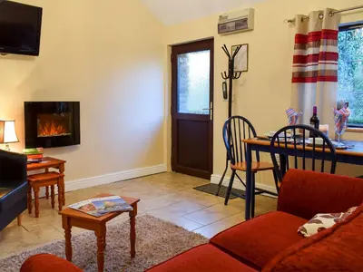 a living room with a couch and a table at Ty Bach Twt in Llangeitho