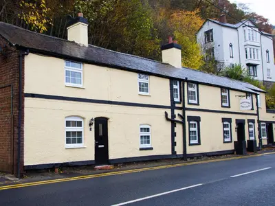 a white building on the side of a street at Minafon in Llangollen