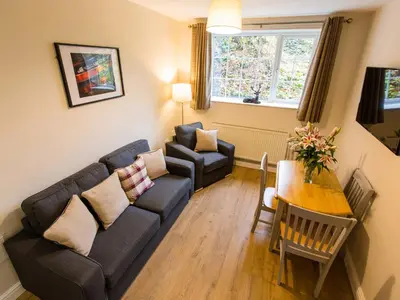 a living room with a couch and a table at Catref in Llangollen