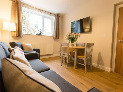 a living room with a couch and a table at Catref in Llangollen