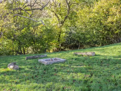 a picnic table in the grass in a field at Dingle Den in Hereford
