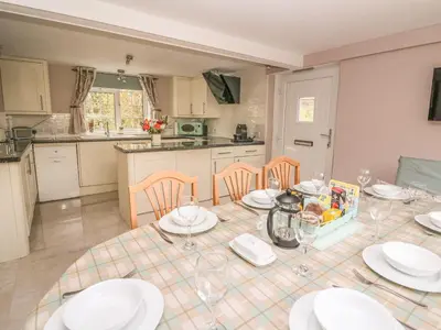a kitchen with a table with plates and glasses on it at Fisher Granary in Lampeter
