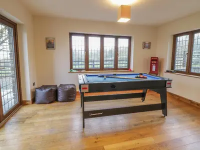 a living room with a pool table in it at Ty Berllan in Caersws