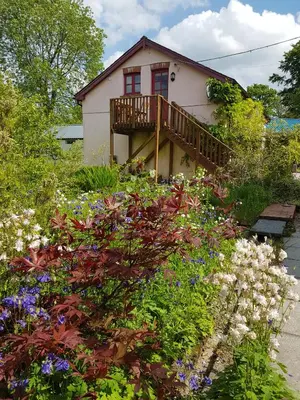 a house with a balcony and a bunch of flowers at Seren Loft - Cynghordy, Llandovery in Llandovery