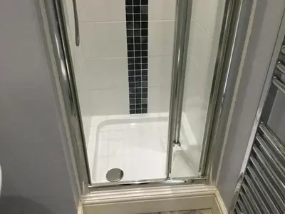 a shower in a bathroom with a glass door at Maes y Gwaelod in Llanwrtyd Wells