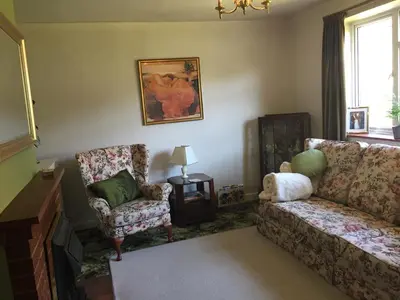 a living room with a couch and a chair at 11 Callow Crescent in Minsterley