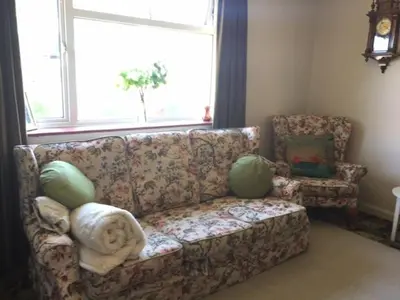 a living room with a couch and a window at 11 Callow Crescent in Minsterley