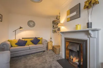 a living room with a couch and a fireplace at Finest Retreats - Tegannedd - Luxury Grade II Listed Cottage With Hot Tub in Ffestiniog