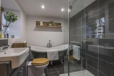 a bathroom with a toilet and a sink and a shower at Finest Retreats - Tegannedd - Luxury Grade II Listed Cottage With Hot Tub in Ffestiniog