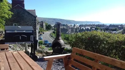 a vase sitting next to a bench next to a street at Apartment Chic in Barmouth