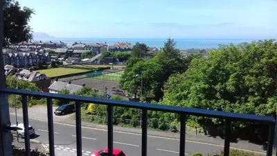 a balcony with a view of a tennis court at Apartment Chic in Barmouth