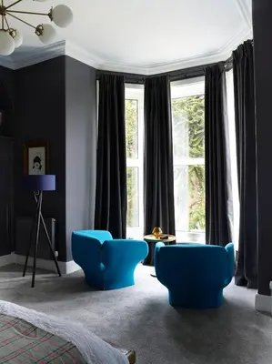 a bedroom with blue chairs in front of a window at The Royston in Llanbrynmair