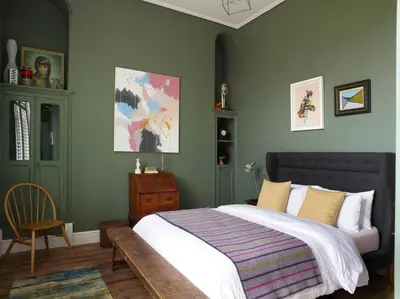 a bedroom with a large bed and a chair at The Royston in Llanbrynmair